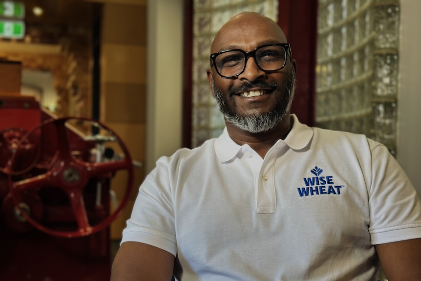 A man wearing a shirt that says 'wise wheat'.