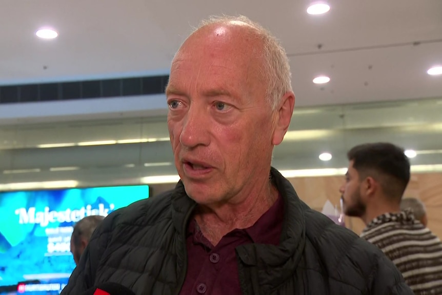 A man speaks at Sydney Airport.