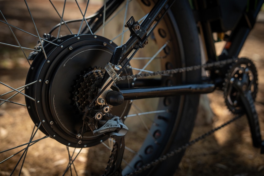 A larger than usual motor attached to the back wheel and chains