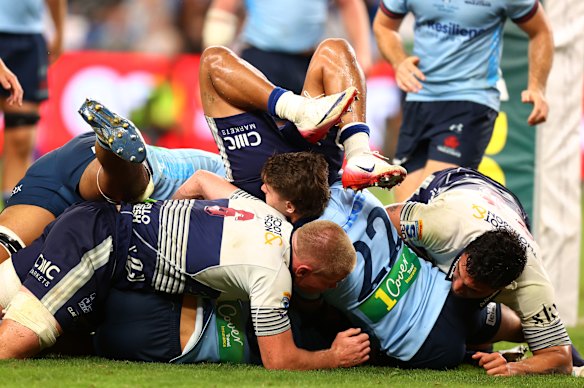 Bradley Slater of the Blues is held up over the line.