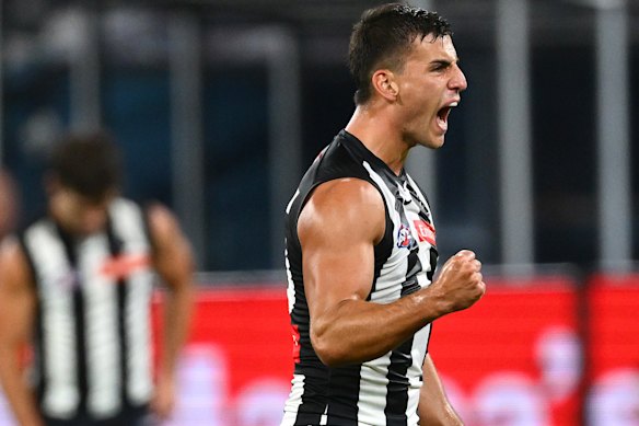 Nick Daicos of the Magpies celebrates kicking a goal.
