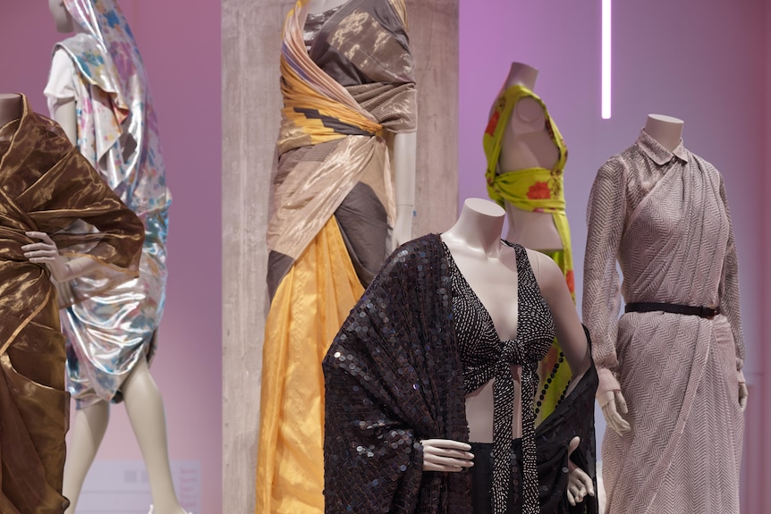 Multiple mannequins dressed in saris inside an exhibition