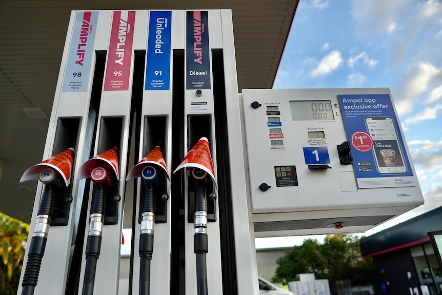 A Sydney petrol station with four bowsers covered in a sign that reads Sorry temporarily out of order