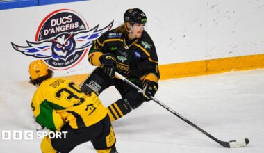 Chase Pearson of Nottingham Panthers looks to keep the puck from Jean Dupuy of GKS Katowice