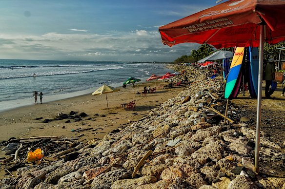 The famous Kuta Beach has been hollowed out by erosion. A jogging path that used to top these rocks has been washed away. 