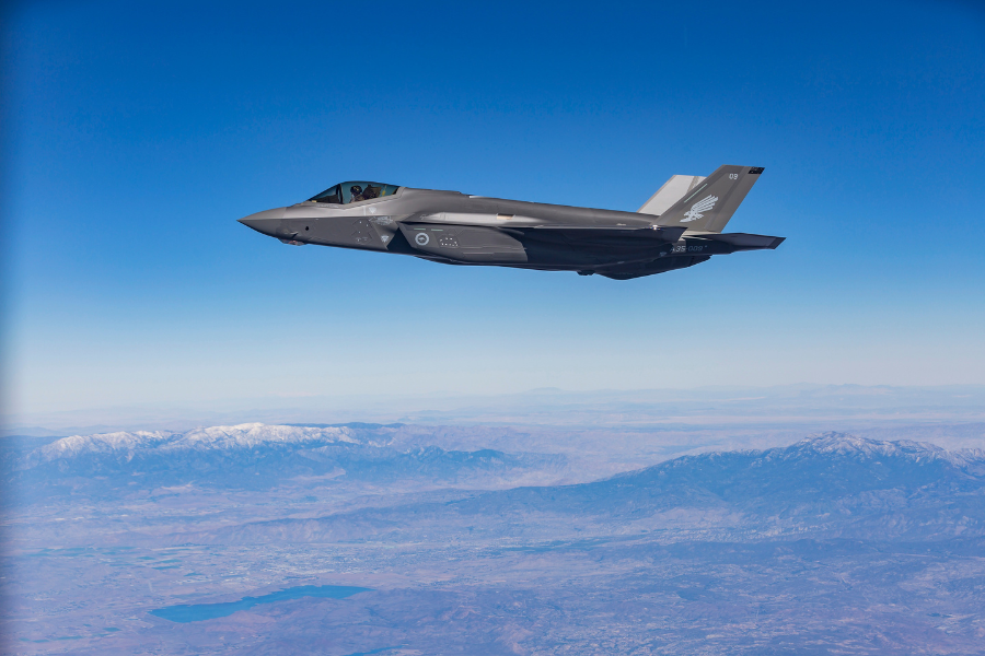 One of Australia’s first two F-35A aircraft A35-009_Lockheed Martin in flight over a rugged landscape