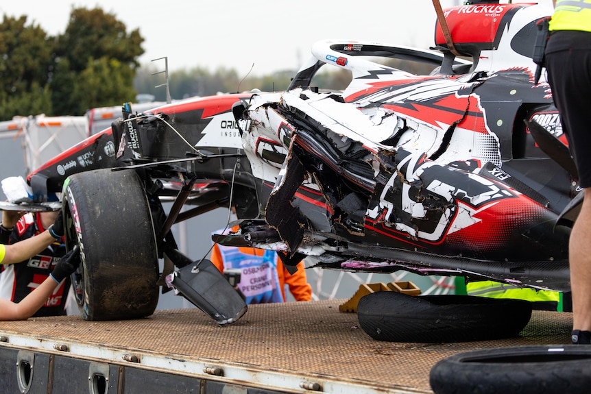 Wrecked and mangled F1 car on the back of the truck