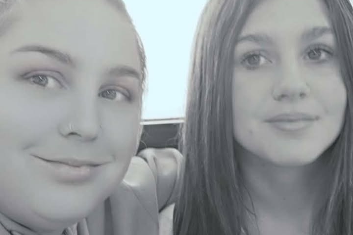 two women in black and white photo smiling