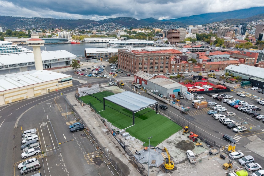A large roofed structure on grass