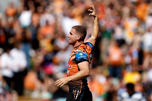 Adam Doueihi celebrates his try for the Tigers against North Queensland.