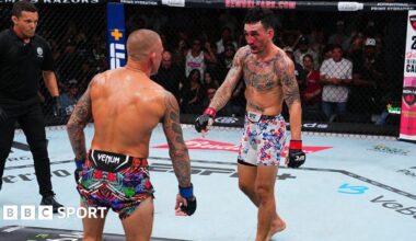 Max Holloway points down towards the end of his fight with Dustin Poirier in 2025