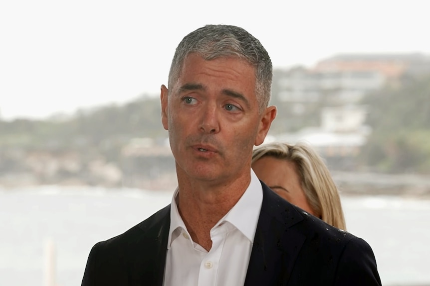 John Graham NSW Transport Minister talks to the media outdoors