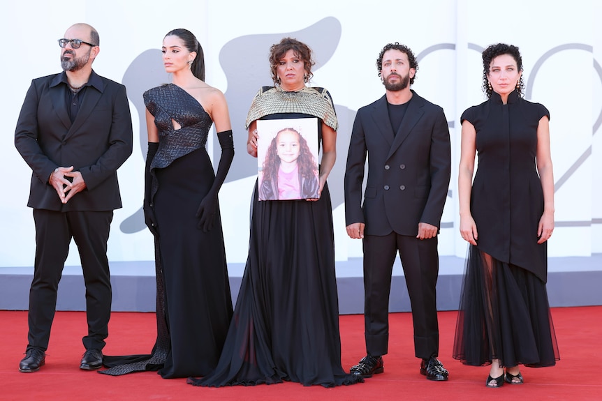 Amer Hlehel, Saja Kilani, Kaouther Ben Hania, Motaz Malhees and Clara Khoury with a photo of Hind Rajab