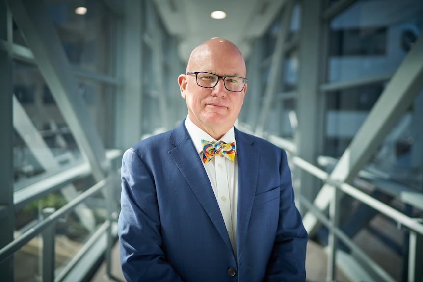 Man in a blue suit jacket and white shirt.