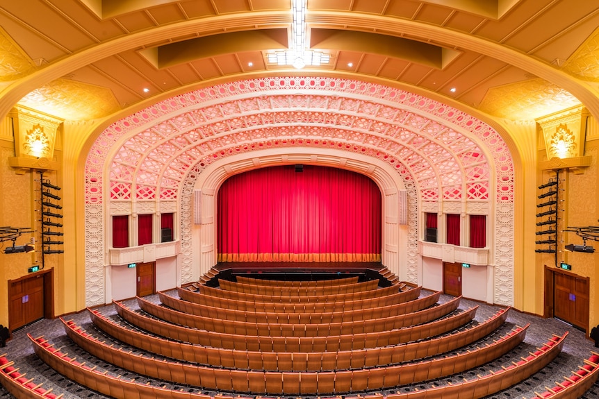 picture of an art deco theatre featuring stage and seats