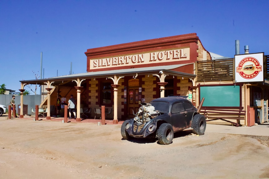 An outback pub with an old black VW car out the front.