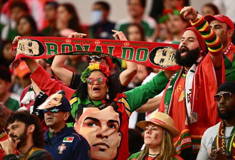 A Portuguese fan shows a scarf depicting Portugal's forward Cristiano Ronaldo during a friendly football match between Mexico and Portugal at the Banorte (formerly known as Azteca) Stadium in Mexico City on March 28, 2026. (Photo by CARL DE SOUZA / AFP)