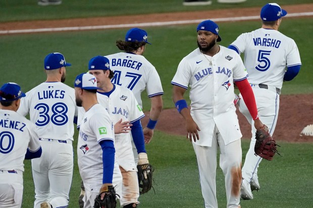 Toronto Blue Jays players celebrate after Game 1 of baseball's World Series against the Los Angeles Dodgers, Friday, Oct. 24, 2025, in Toronto. (AP Photo/David J. Phillip)