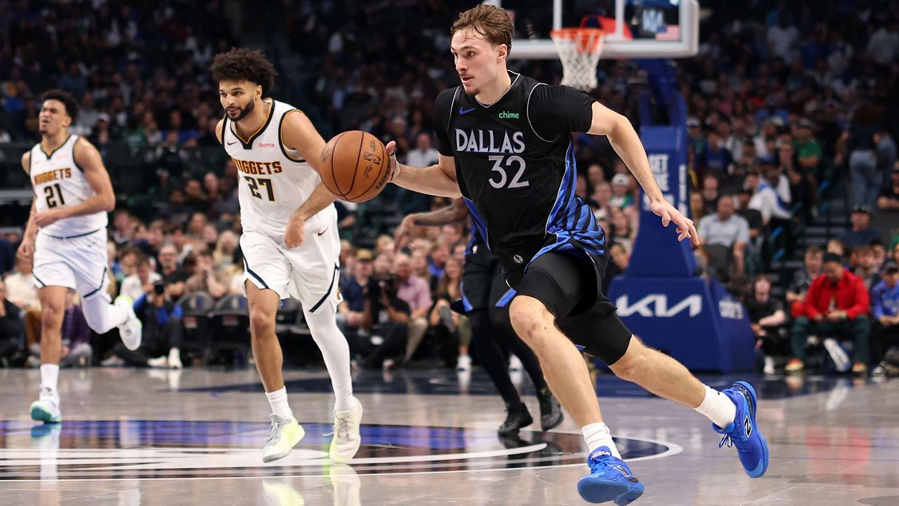 Dallas Mavericks forward Cooper Flagg (32) brings the ball up the court during the third quarter of an NBA basketball game against the Denver Nuggets Tuesday, Dec. 23, 2025, in Dallas. (AP Photo/Sam Hodde)