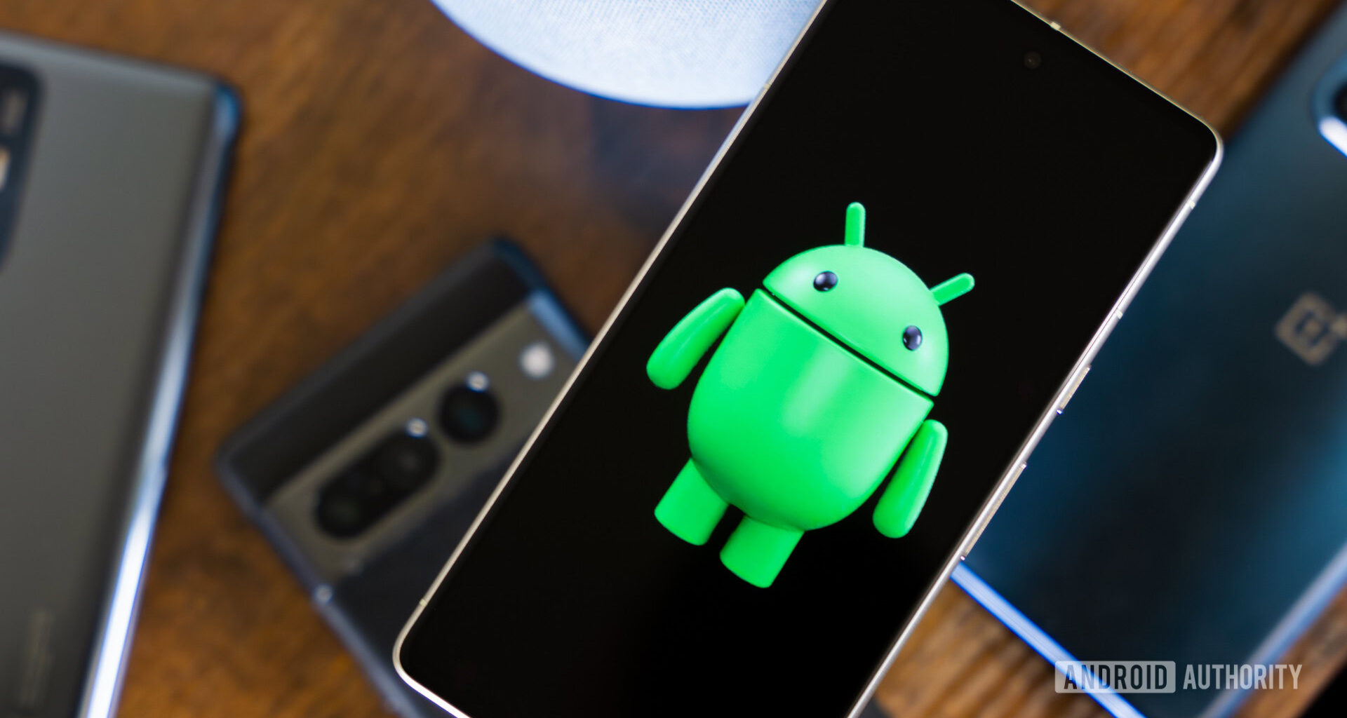 Android robot on smartphone next to other devices and accessories (2)