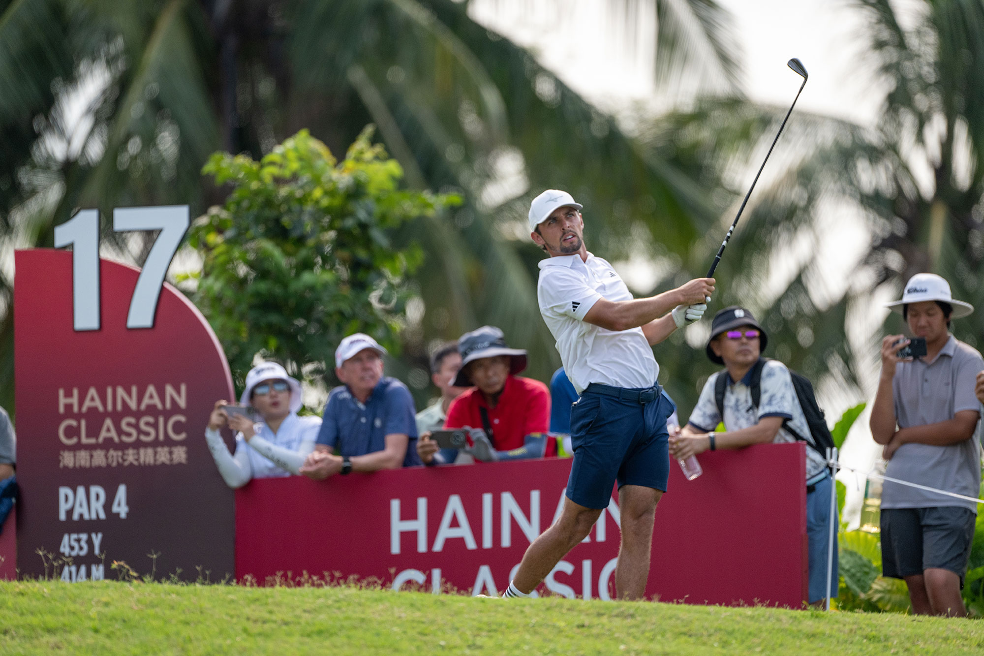 Marco Penge in the finish position after hitting an iron off the tee on the par-4 17th at the 2025 Hainan Classic, a tournament Penge would go on to win