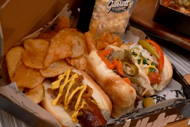 All Star Chicago Line Up, sampler side of platter of charred kielbasa with caramelized onion, and mustard, Buena Italian beef with sweet peppers and giardiniera, Vienna Chicago-Style hog dog, and Garrett stadium buttery popcorn, on display, as the Chicago White Sox hold a media preview to showcase new food and beverage highlights at Rate Field, Wednesday, March 18, 2026. (Antonio Perez/Chicago Tribune)