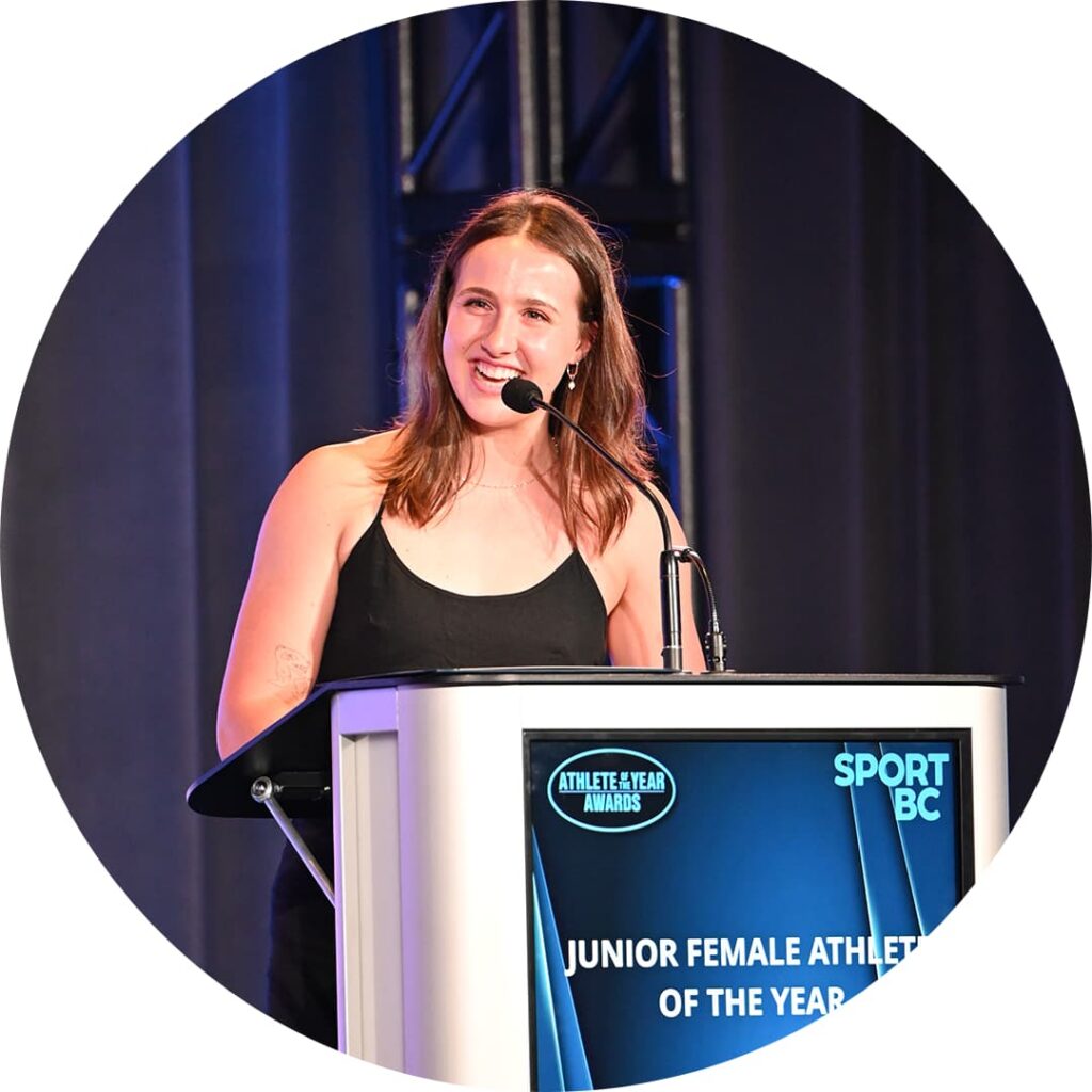woman smiling speaking into a microphone