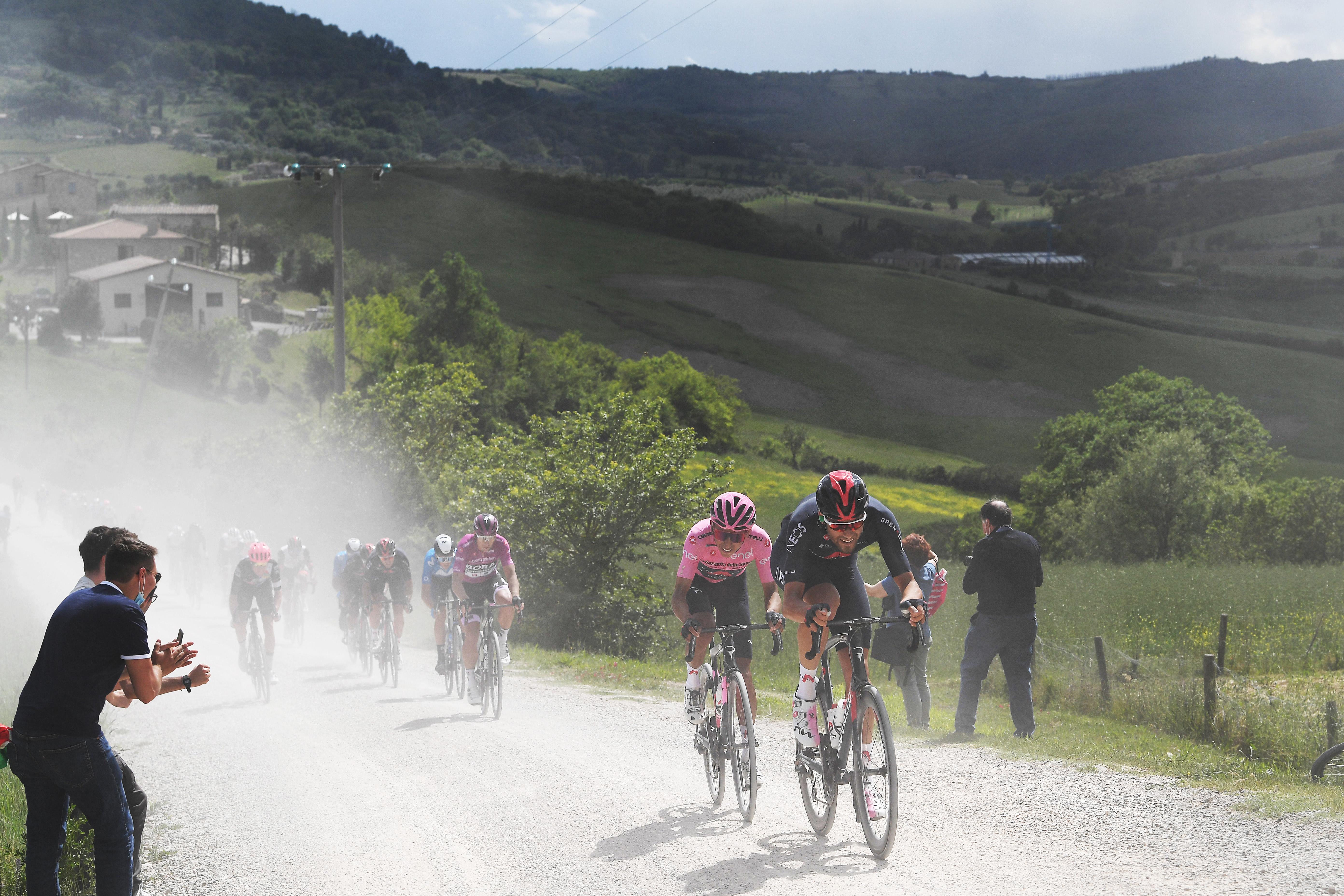 MONTALCINO, ITALY - MAY 19: Egan Arley Bernal Gomez of Colombia Pink Leader Jersey &amp; Filippo Ganna of Italy and Team INEOS Grenadiers passing through a gravel strokes sector during the 104th Giro d&amp;apos;Italia 2021, Stage 12 a 162km stage from Perugia to Montalcino 554m / Fans / Public / Dust / @girodiitalia / #UCIworldtour / #Giro / on May 19, 2021 in Montalcino, Italy. (Photo by Tim de Waele/Getty Images)