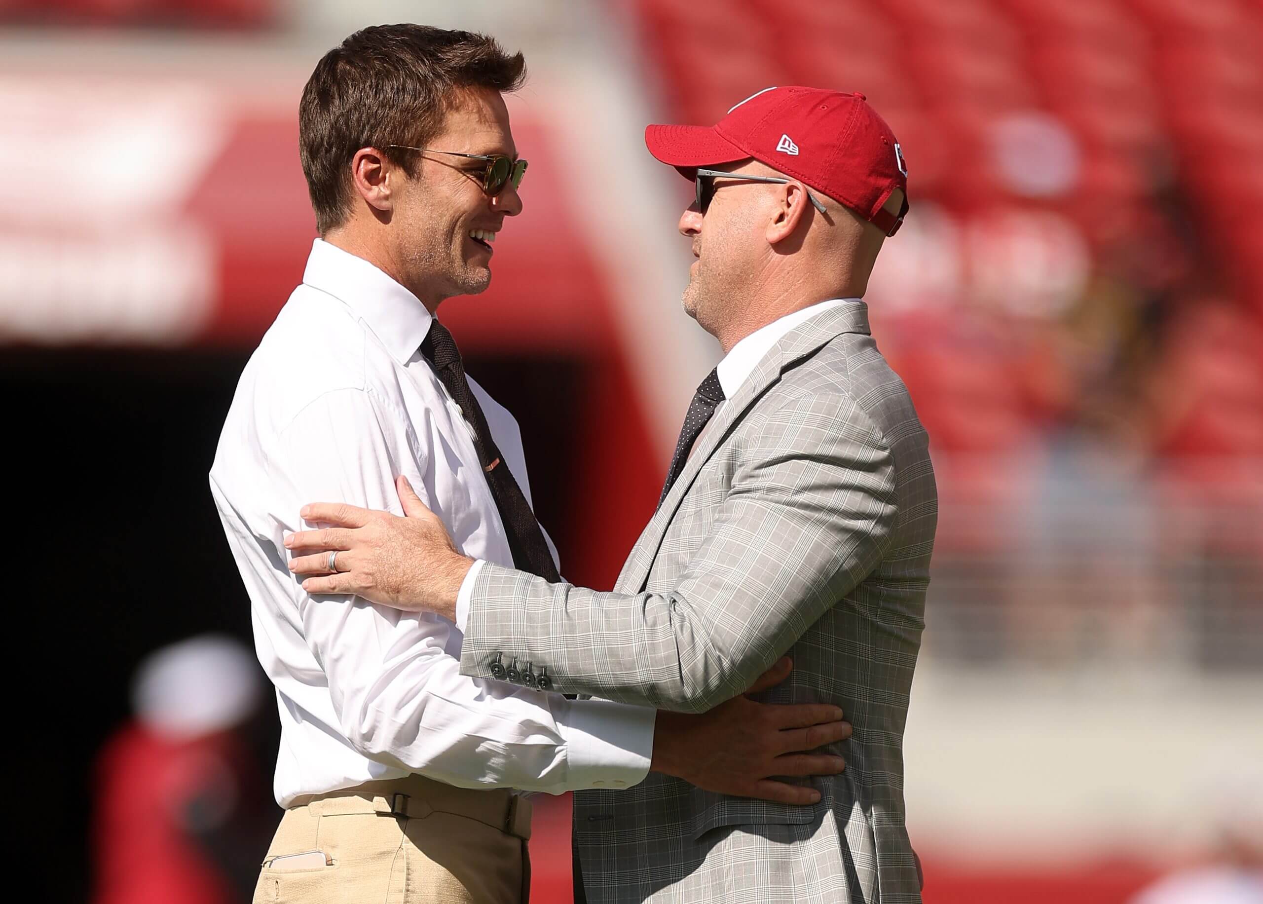 Tom Brady, who has an ownership stake in the Raiders, talks with Cardinals general manager Monti Ossenfort in 2024.