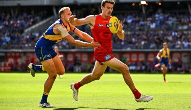 PERTH, AUSTRALIA - MARCH 16: Charlie Ballard of the Suns chases the loose ball in front of Oscar Allen of the Eagles during the 2025 AFL Round 01 match between the West Coast Eagles and the Gold Coast Suns at Optus Stadium on March 16, 2025 in Perth, Australia. (Photo by Daniel Carson/AFL Photos via Getty Images)