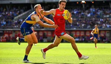 PERTH, AUSTRALIA - MARCH 16: Charlie Ballard of the Suns chases the loose ball in front of Oscar Allen of the Eagles during the 2025 AFL Round 01 match between the West Coast Eagles and the Gold Coast Suns at Optus Stadium on March 16, 2025 in Perth, Australia. (Photo by Daniel Carson/AFL Photos via Getty Images)