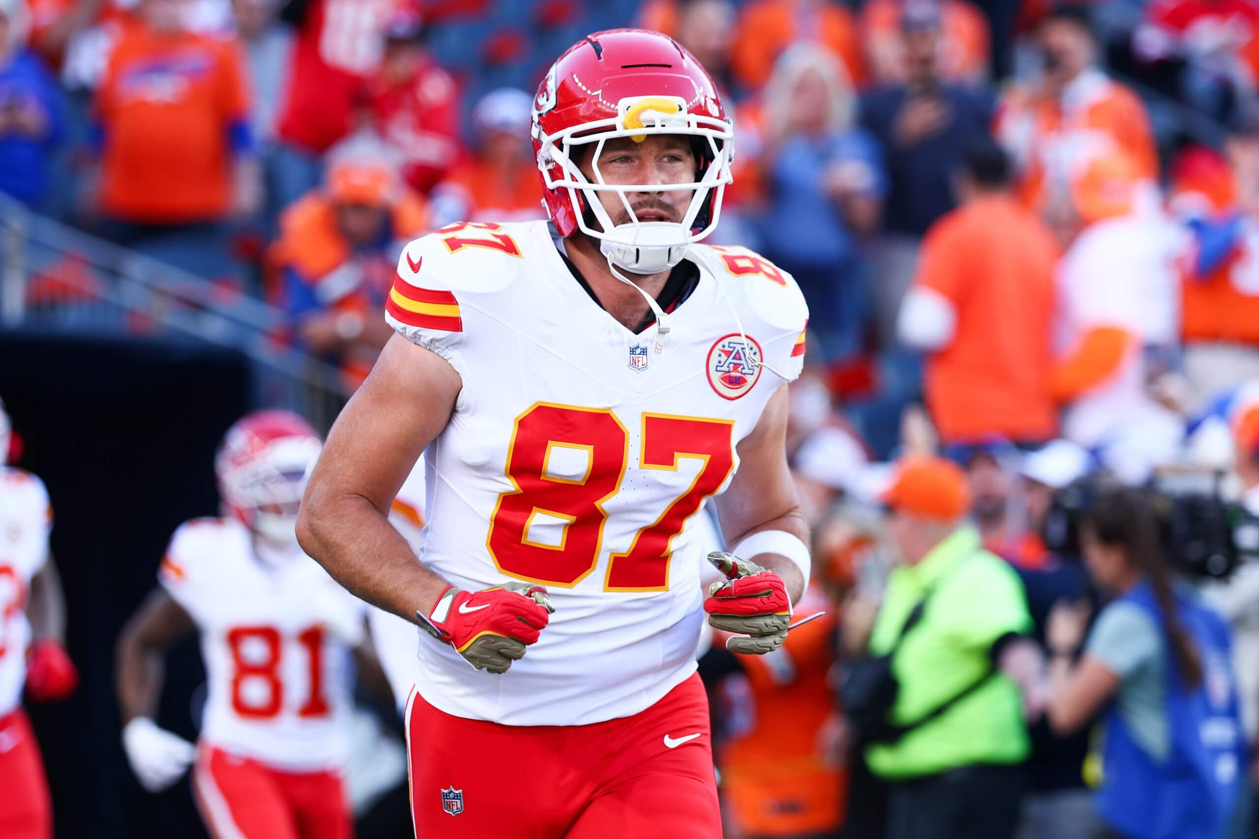 Travis Kelce #87 of the Kansas City Chiefs runs onto the field during the game against the Denver Broncos