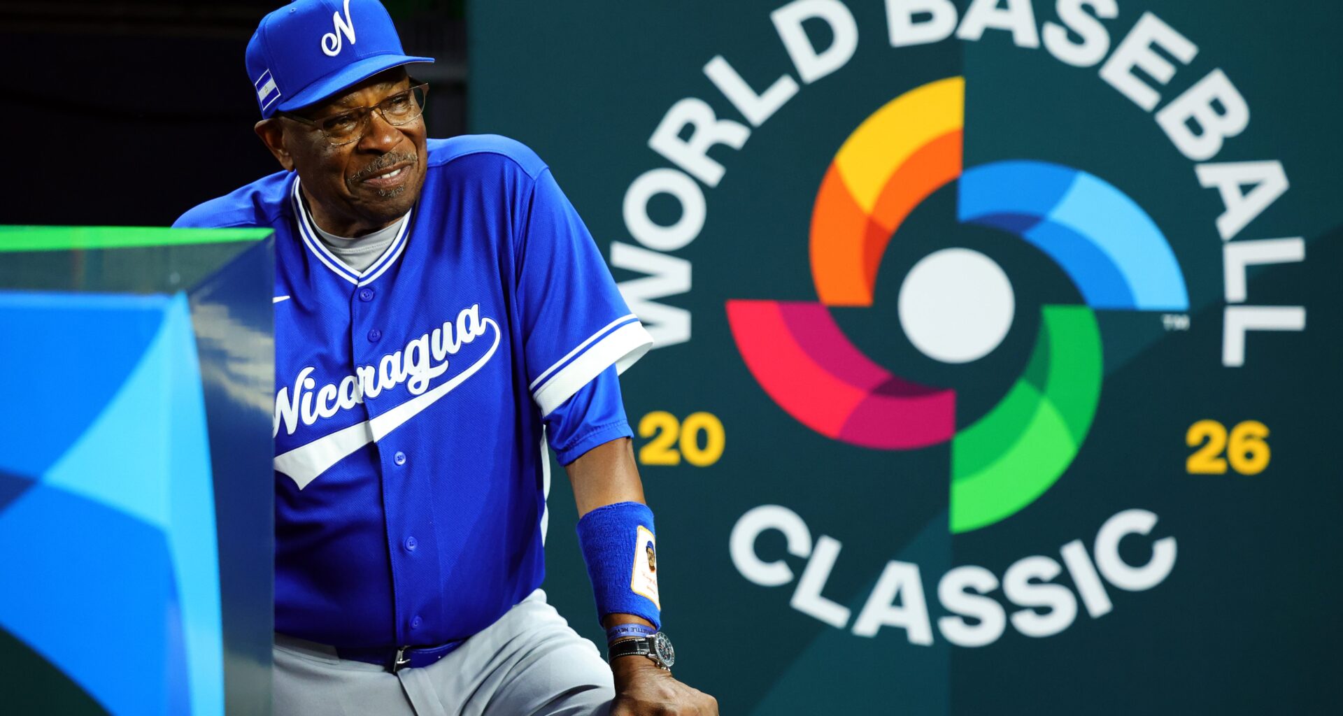 Manager Dusty Baker Jr. of Team Nicaragua stands in the dugout in front of the World Baseball Classic logo.