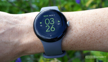 A Google Pixel Watch on a user's wrist displays the watch face.