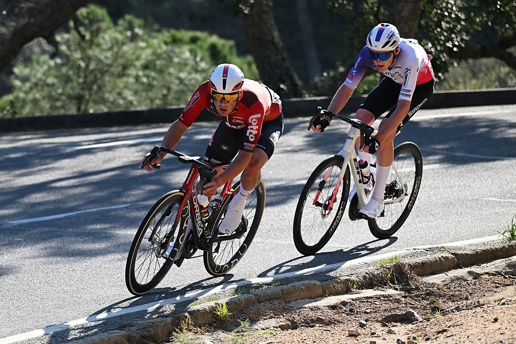 Veistroffer and Burnett riding in tandem on a shade-dappled road