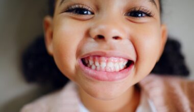 Close up of young girl with big grin showing her teeth