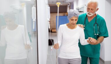 Woman with cancer during chemotherapy walking around the hospital, aided my doctor