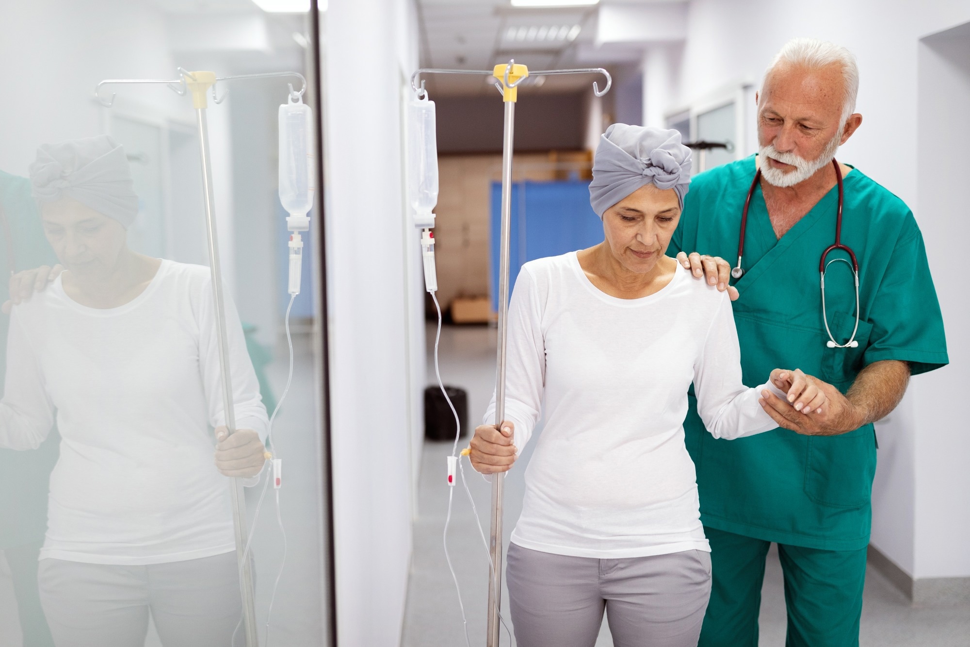 Woman with cancer during chemotherapy walking around the hospital, aided my doctor