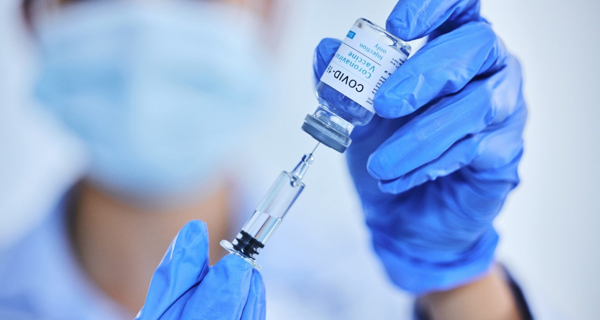 Person, hand and vaccine bottle with needle for treatment or control for virus