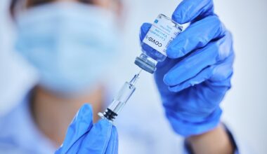 Person, hand and vaccine bottle with needle for treatment or control for virus