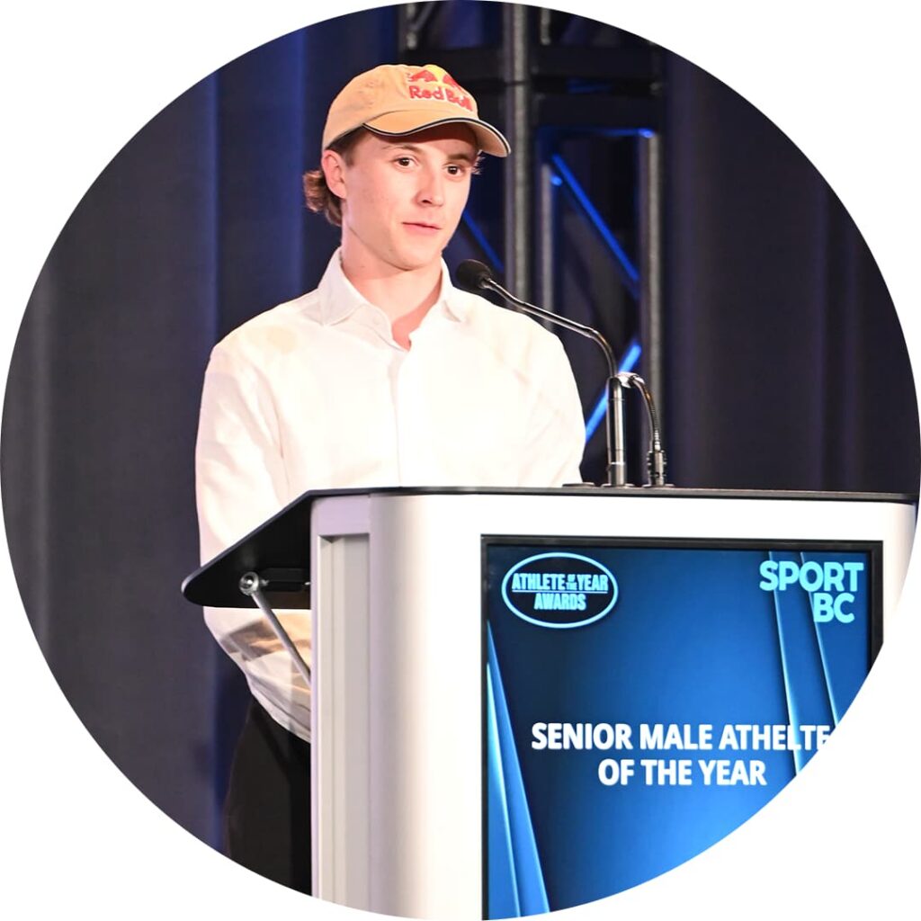 Man looking ahead, speaking into a microphone