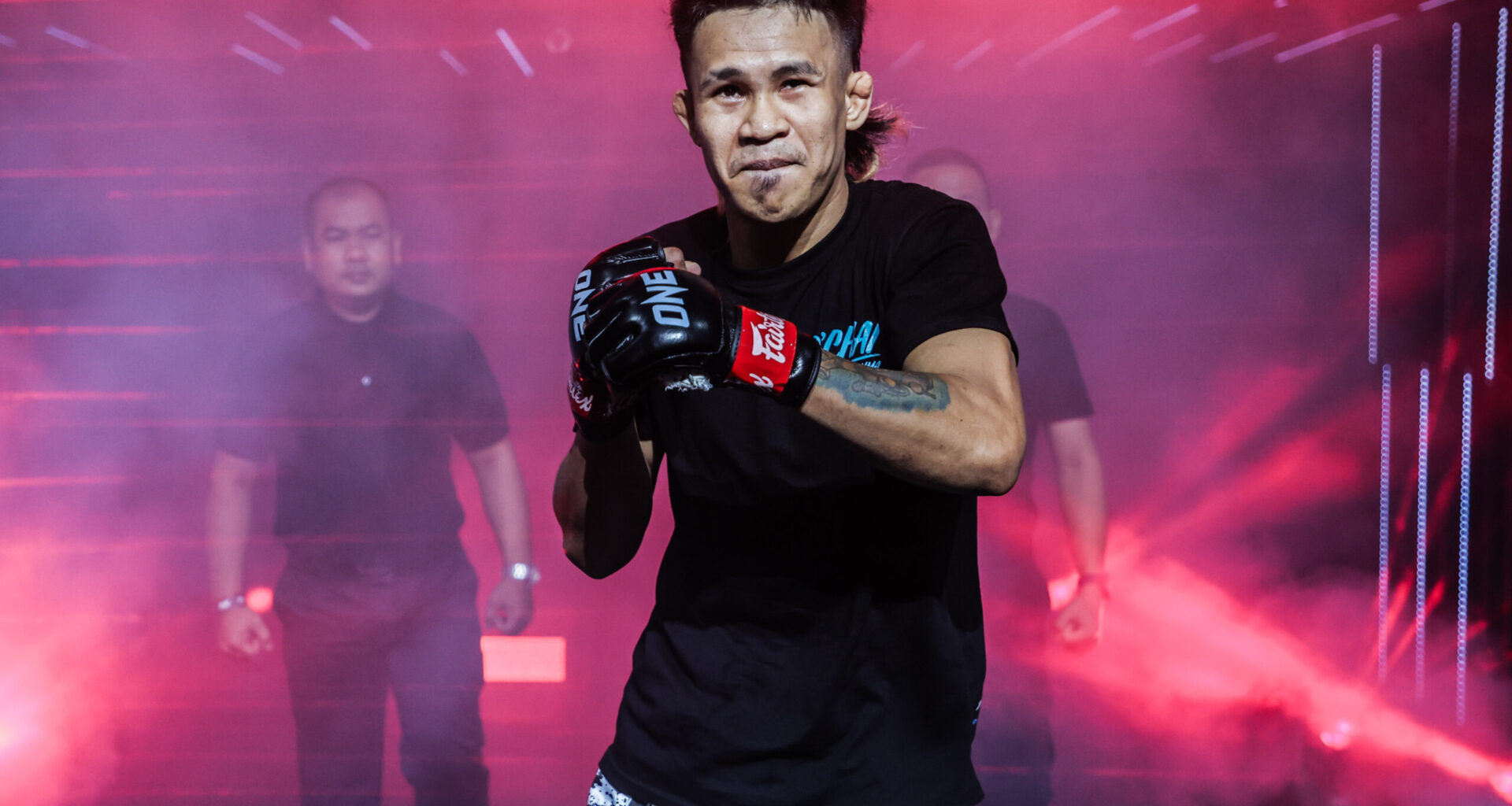 Filipino MMA fighter Jeremy Miado shadowboxes as he makes his entrance