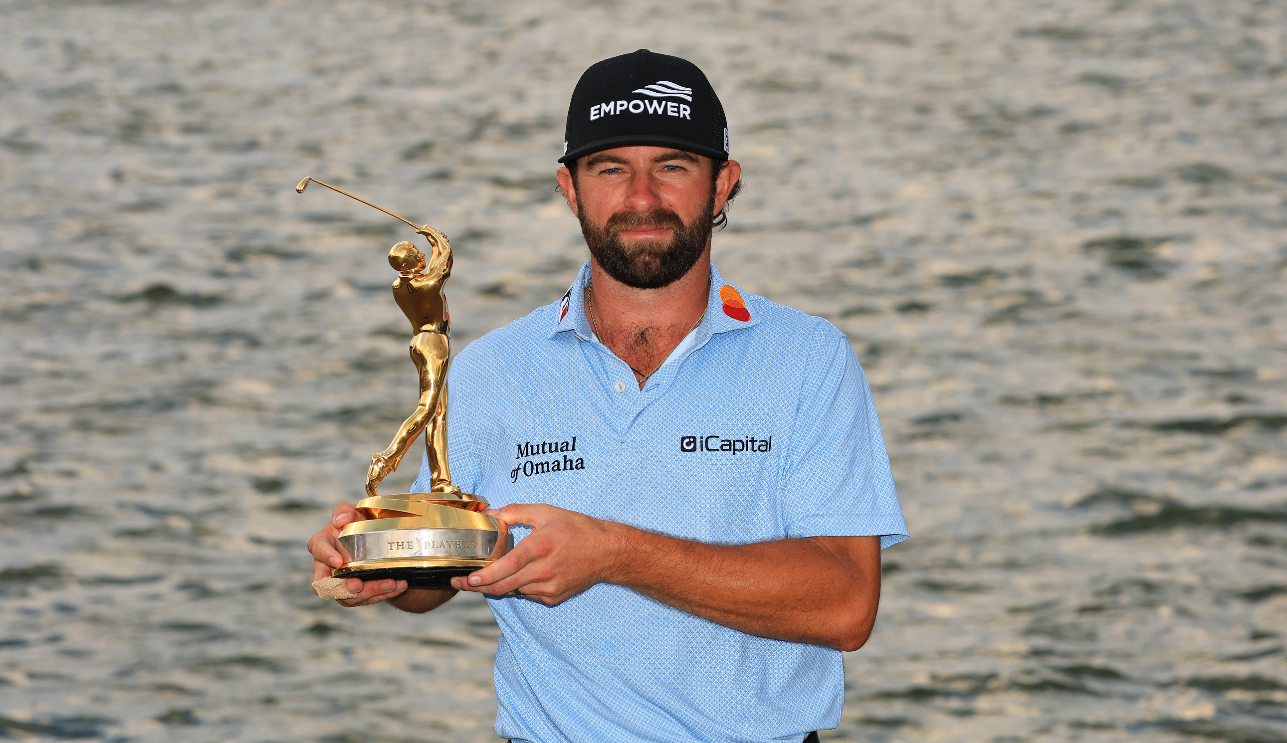 Cameron Young poses with The Players Championship trophy