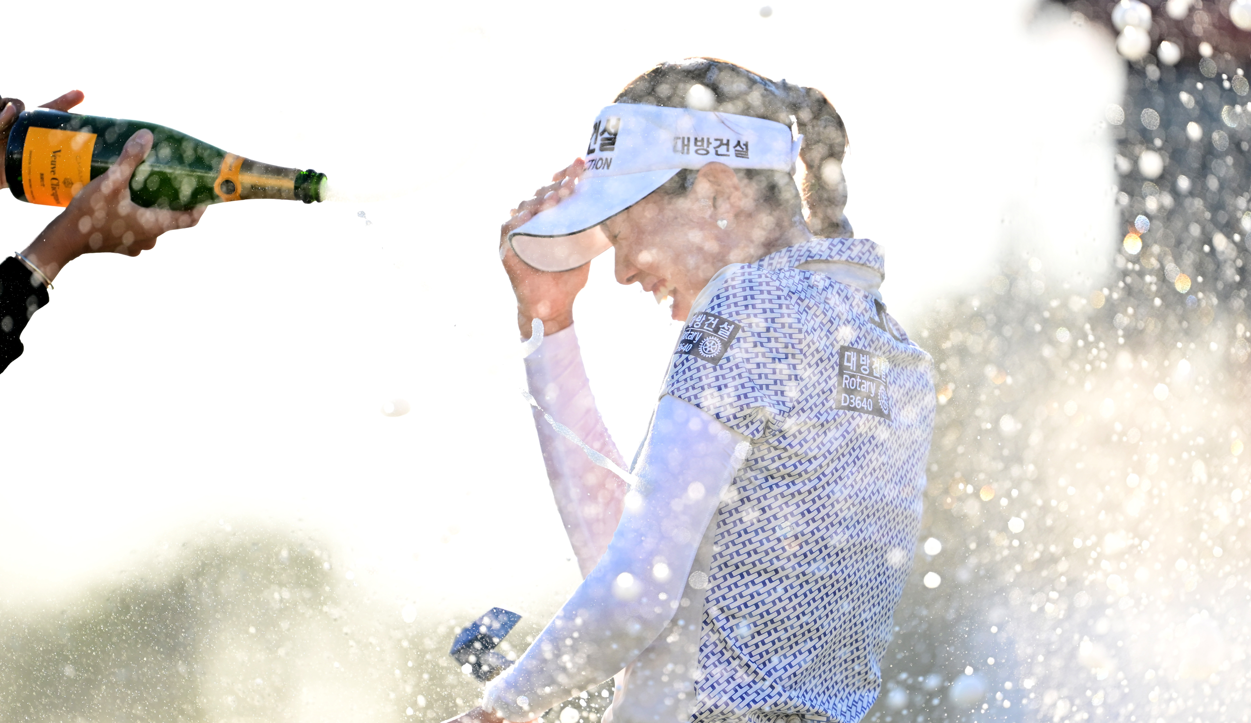 Yealimi Noh gets sprayed with champagne
