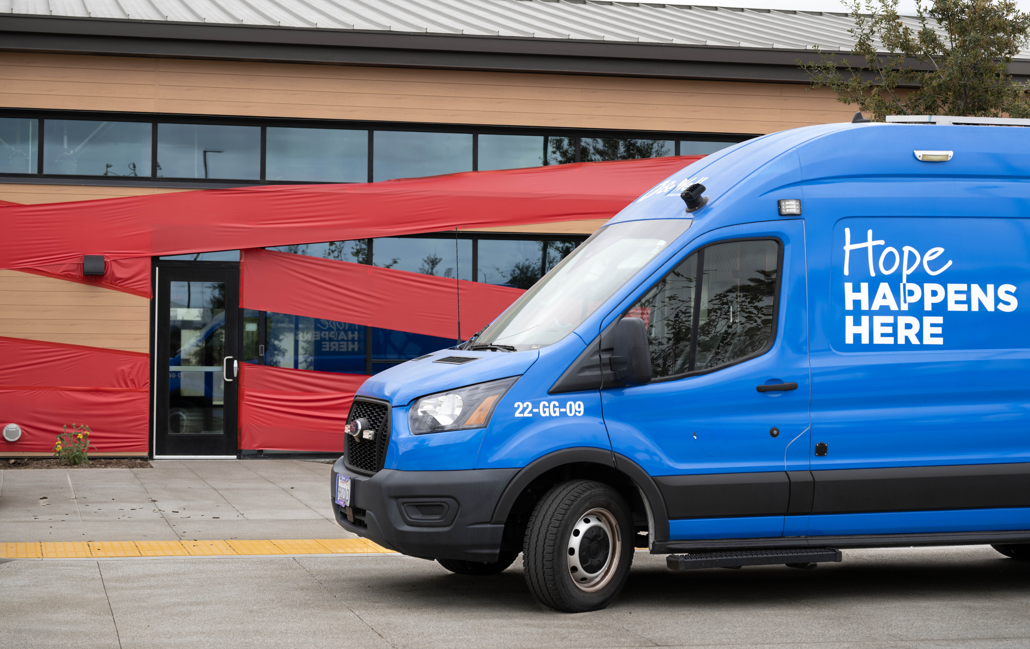 A Be Well OC mental health van sits in front...