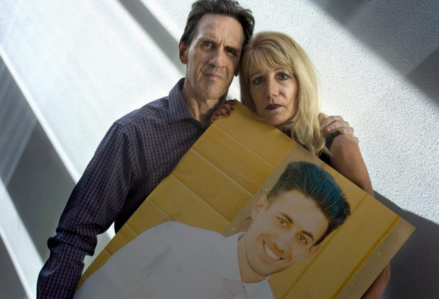 Rose and Allen Nelson of Santa Monica hold a picture of their son Brandon Nelson in 2018. (Photo by Mindy Schauer, Orange County Register/SCNG)