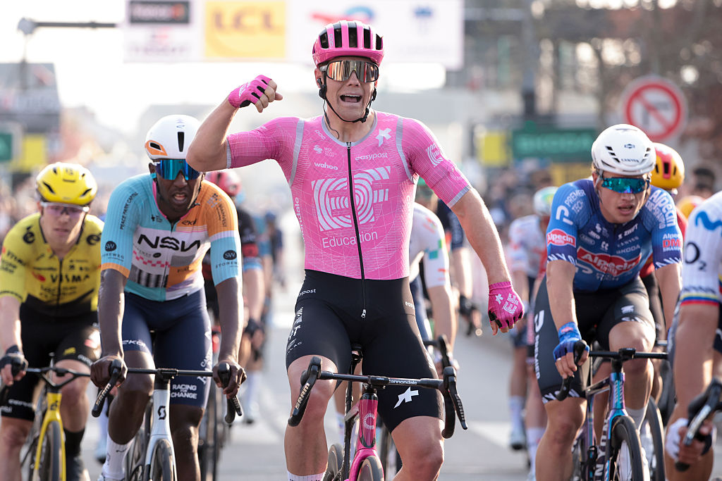Luke Lamperti raises an arm in celebration after winning stage 1 of Paris-Nice