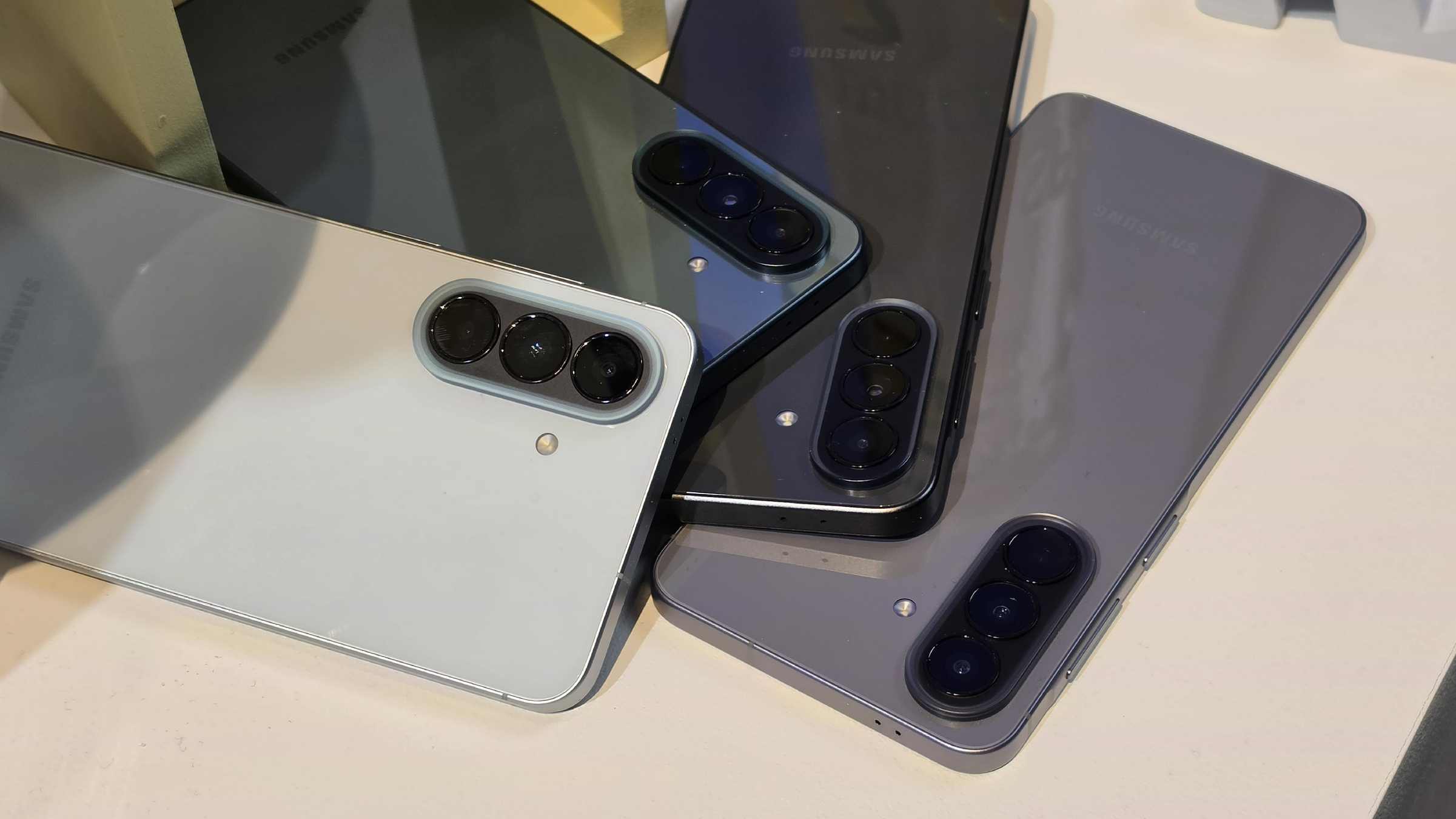 A selection of Samsung Galaxy A57 and Samsung Galaxy A37 units on a table.