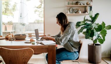 Woman sitting at desk looking at laptop