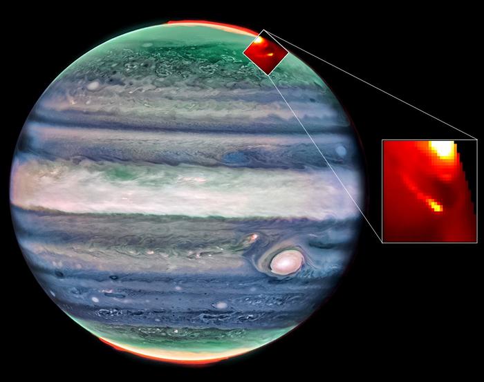 A view of Jupiter with a section of the top of the world enlarged. In the boxout, it's a reddish area with a bright yellow spot.